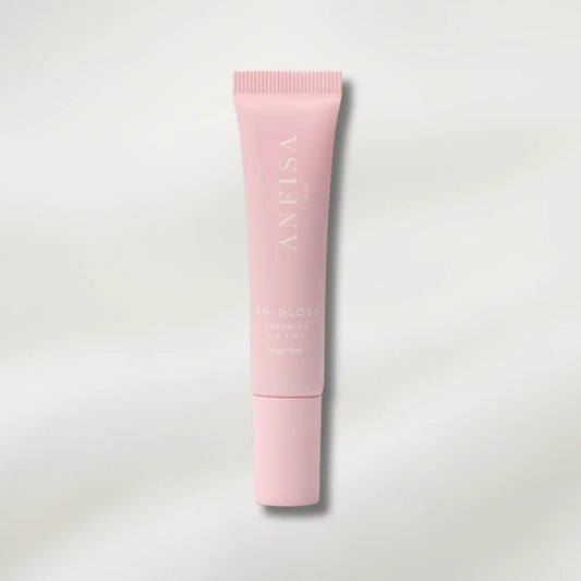 Pink skincare tube with brand name on a light gray background