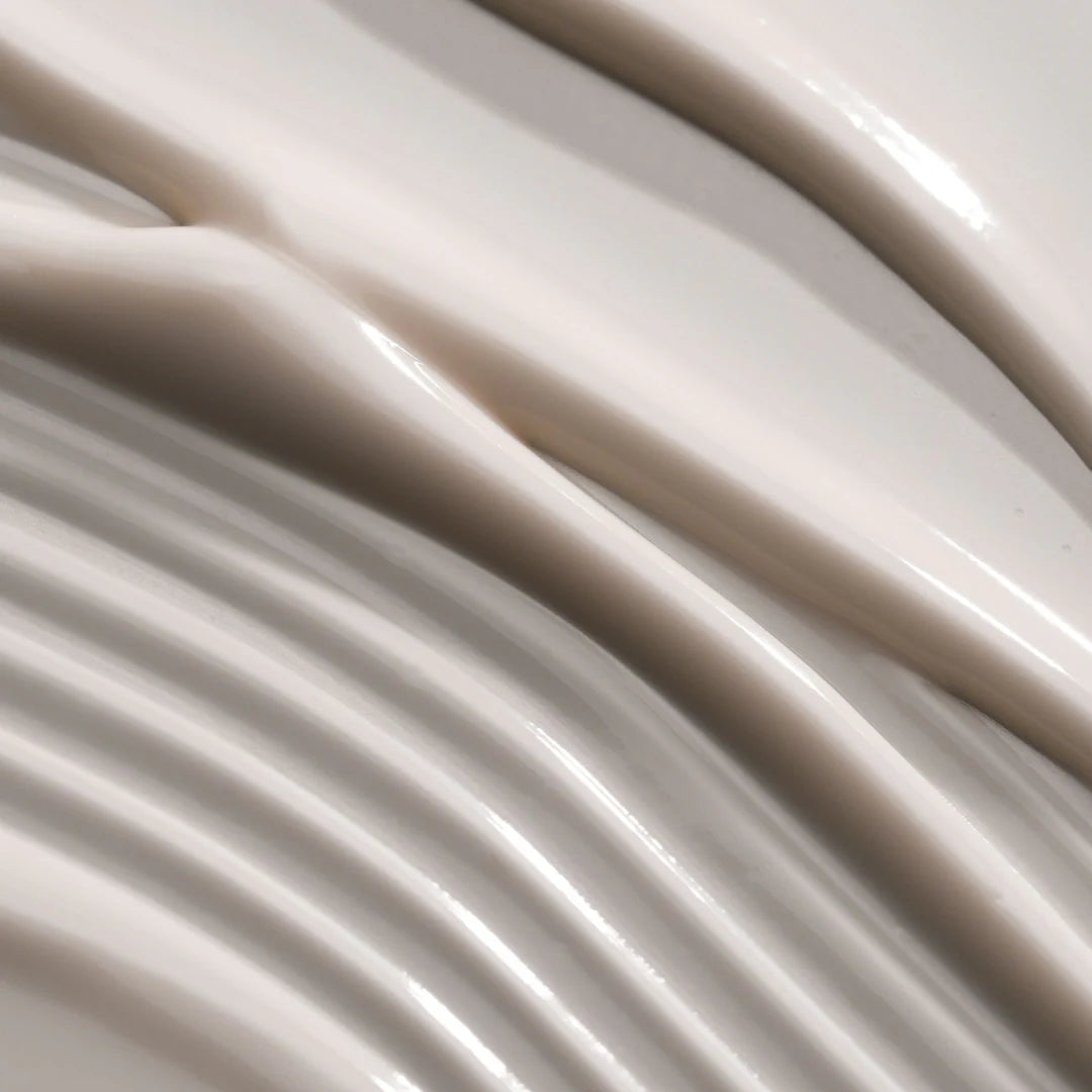 Close-up of smooth, beige fabric with soft folds