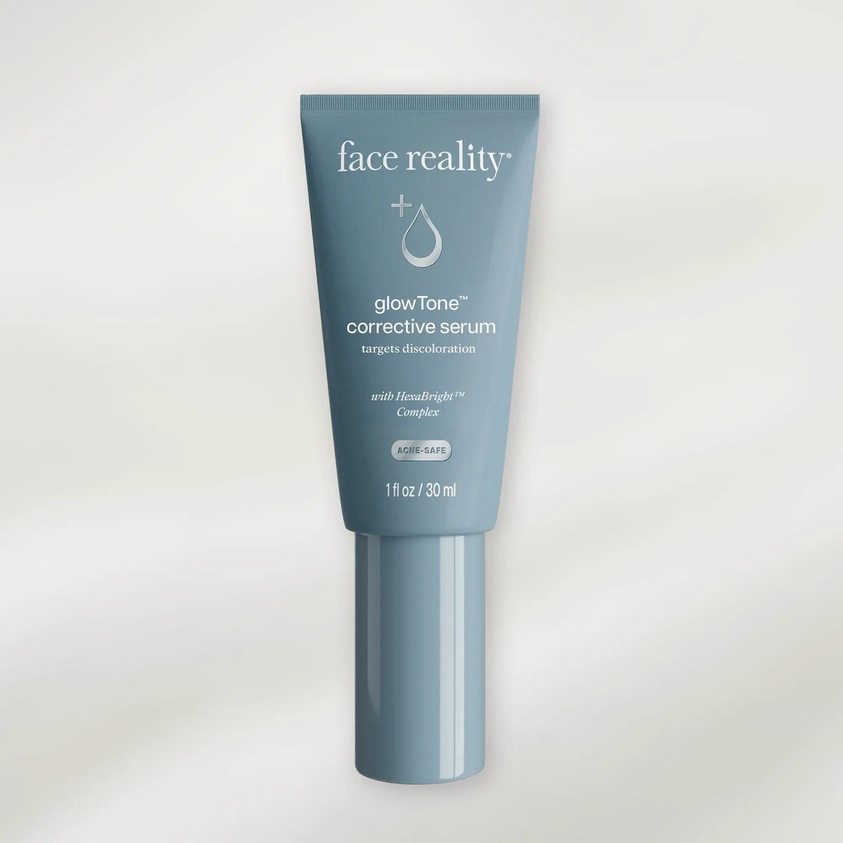 Tube of 'face reality' glow tone corrective serum on a white background