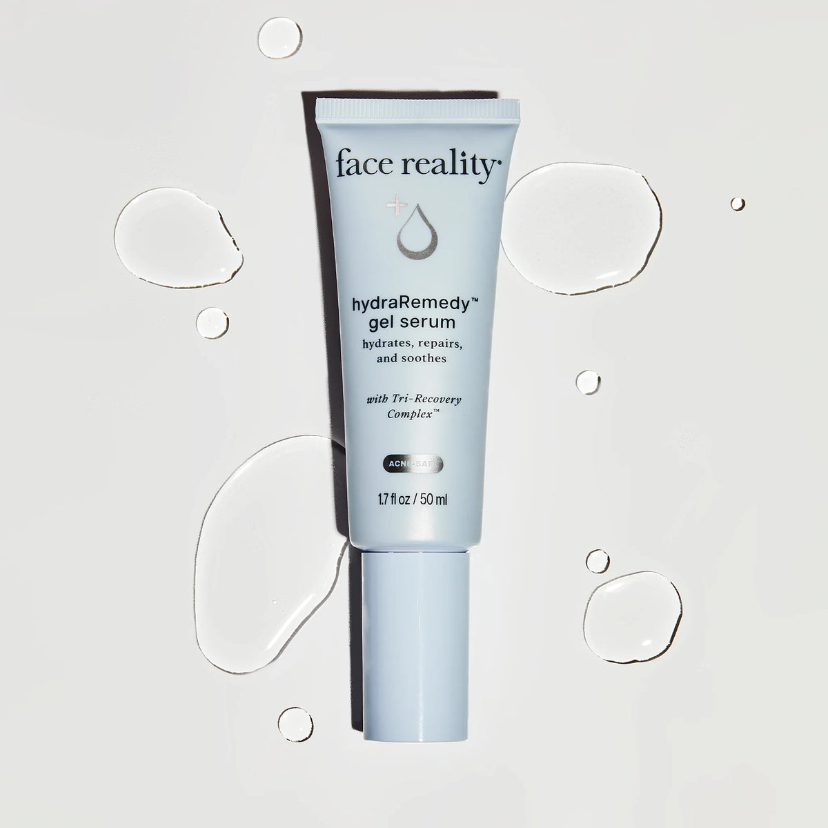 Tube of face reality hydra remedy gel serum on a light gray background with water droplet graphics.