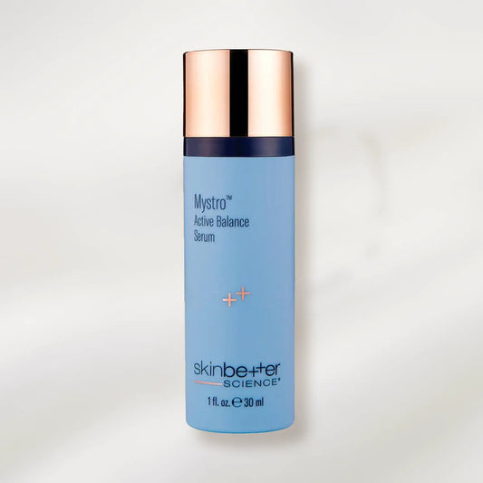 Blue serum bottle with rose gold cap on a light gray background