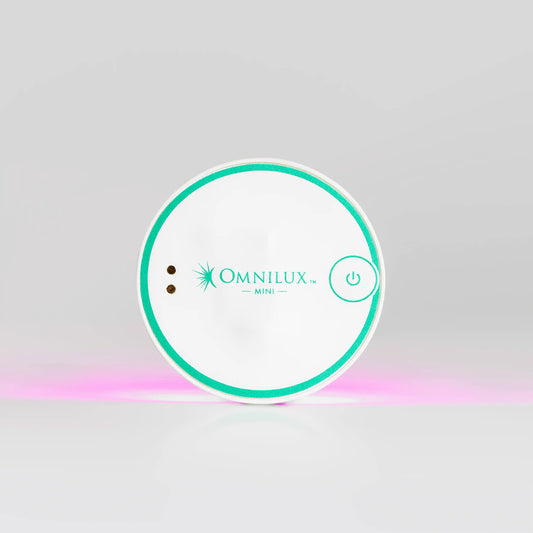 Omnilux Mini device on a gray background