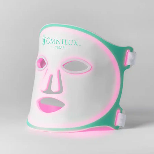 Omnilux LED face mask with pink and green design on a gray background