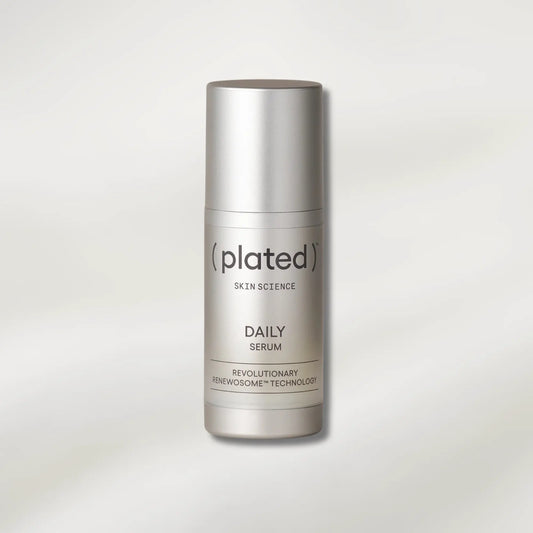 A silver cylindrical bottle of (Plated) Skin Science Daily Serum, centered on a light gray background with a soft shadow.