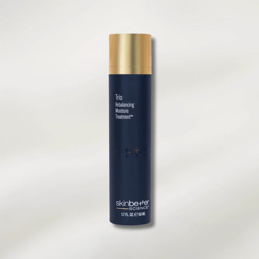 Blue skincare bottle with gold cap on a light gray background