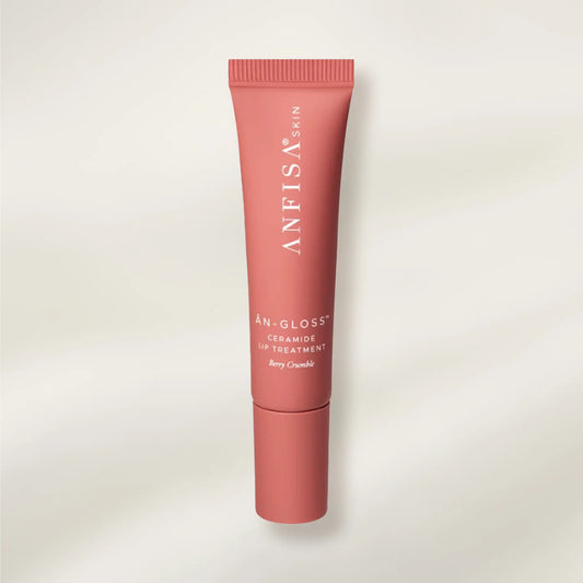 Pink lip balm tube with 'ANFISA' branding on a light beige background