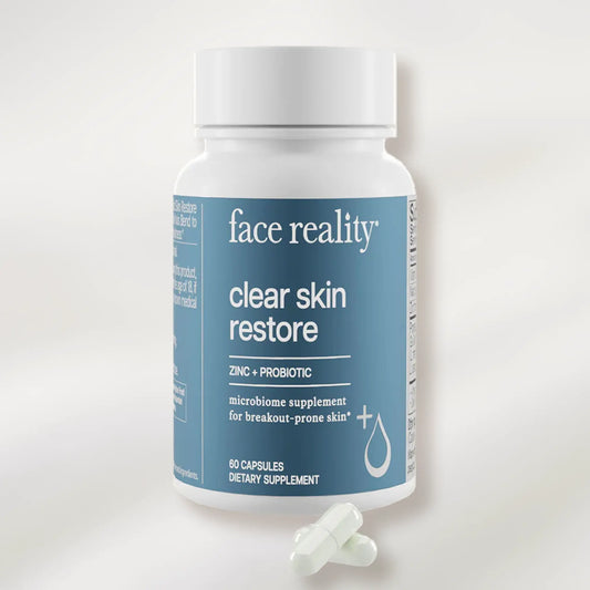 Supplement bottle labeled 'face reality clear skin restore' on a white background