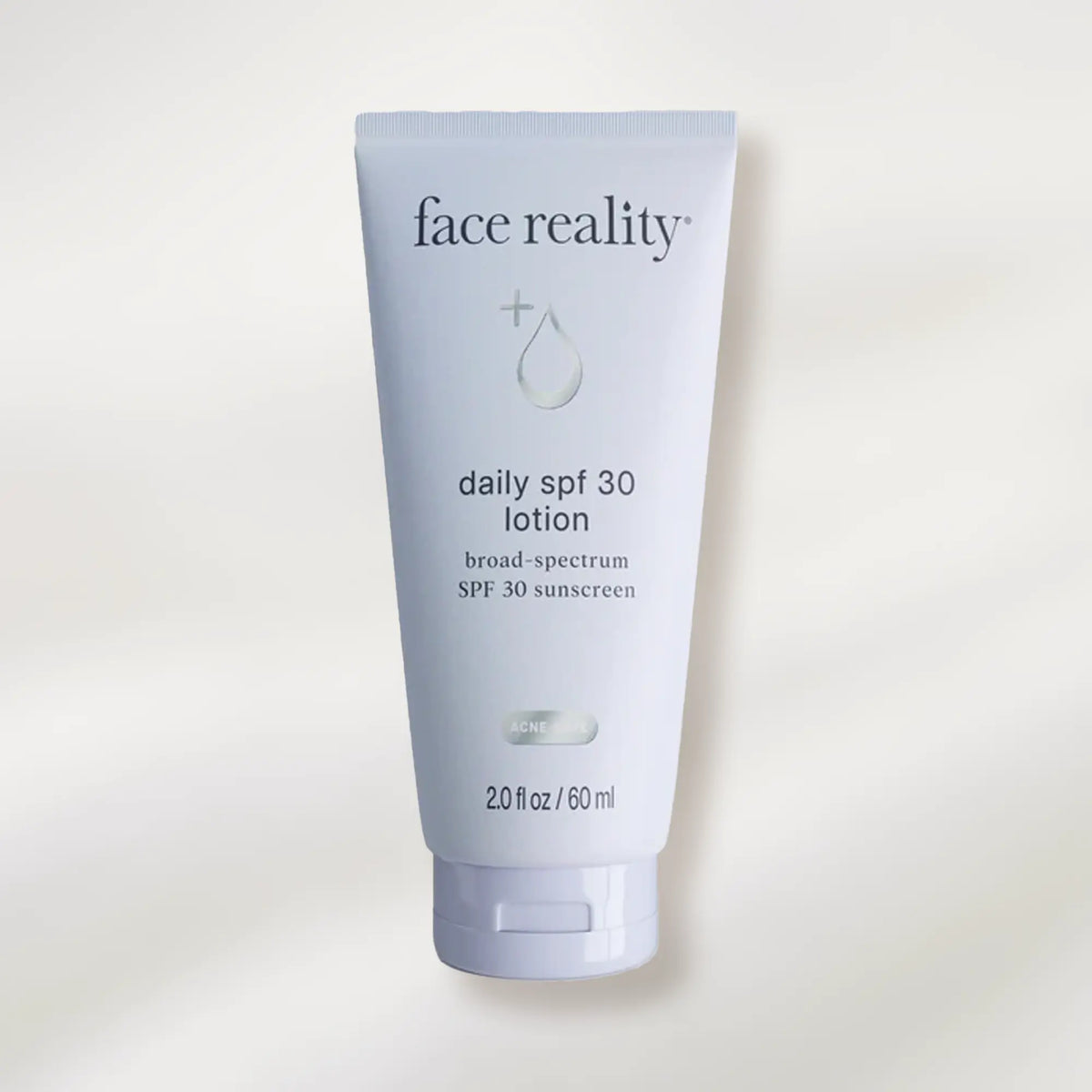 Tube of 'face reality' daily SPF 30 lotion on a white background