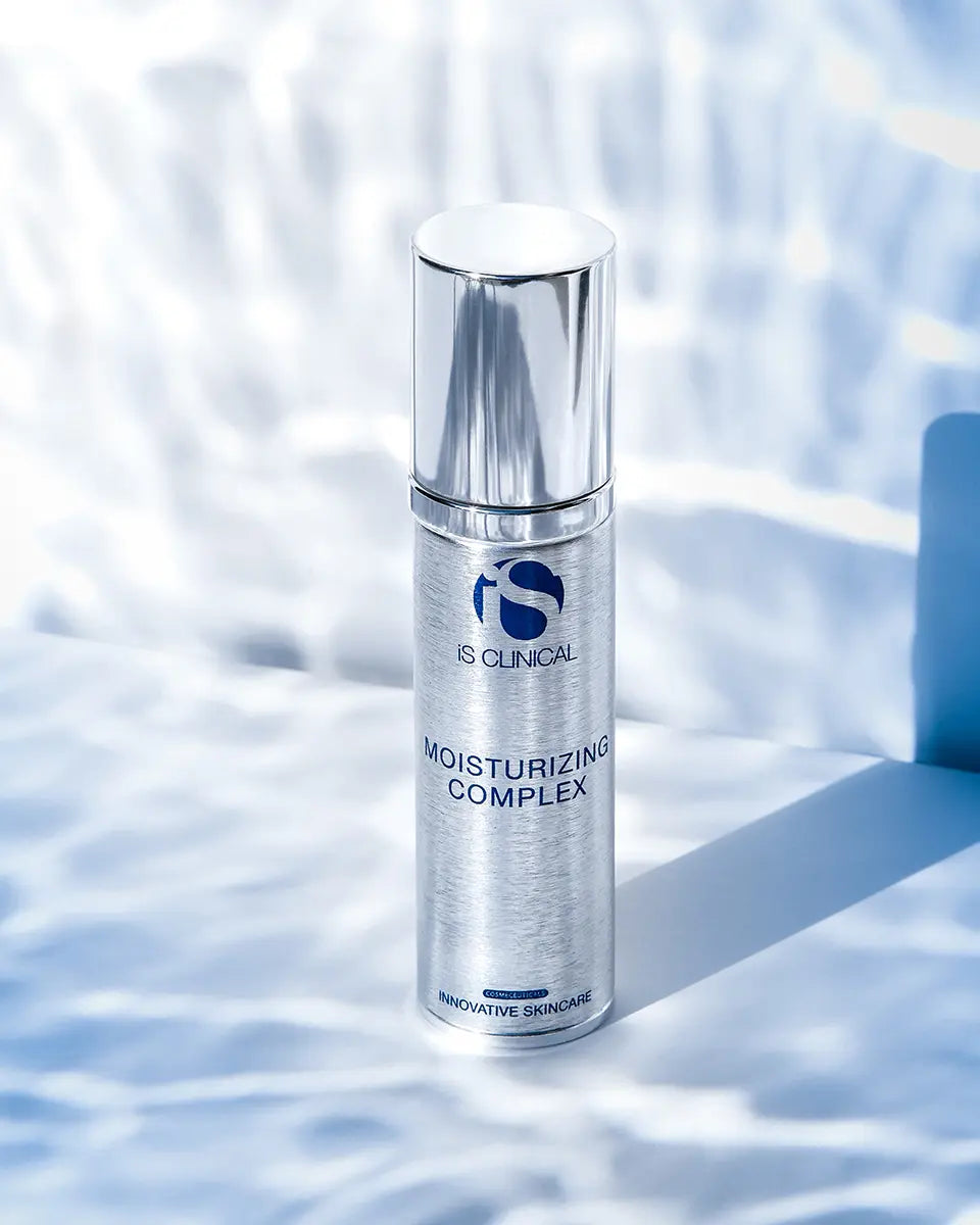 Skincare bottle labeled 'IS Clinical' on a textured white background