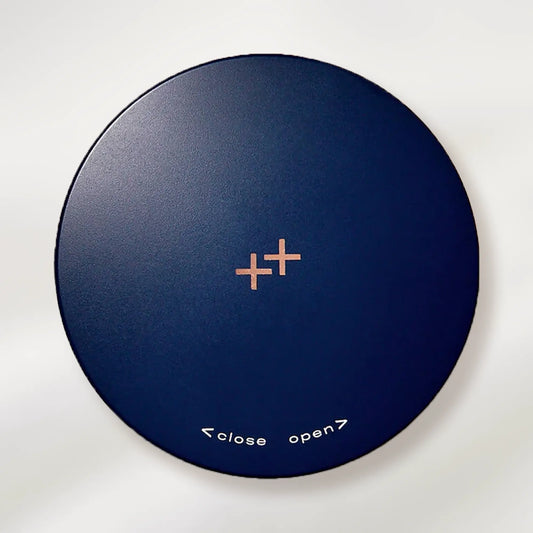 Round blue compact with '+' symbol and 'close open' text on a white background